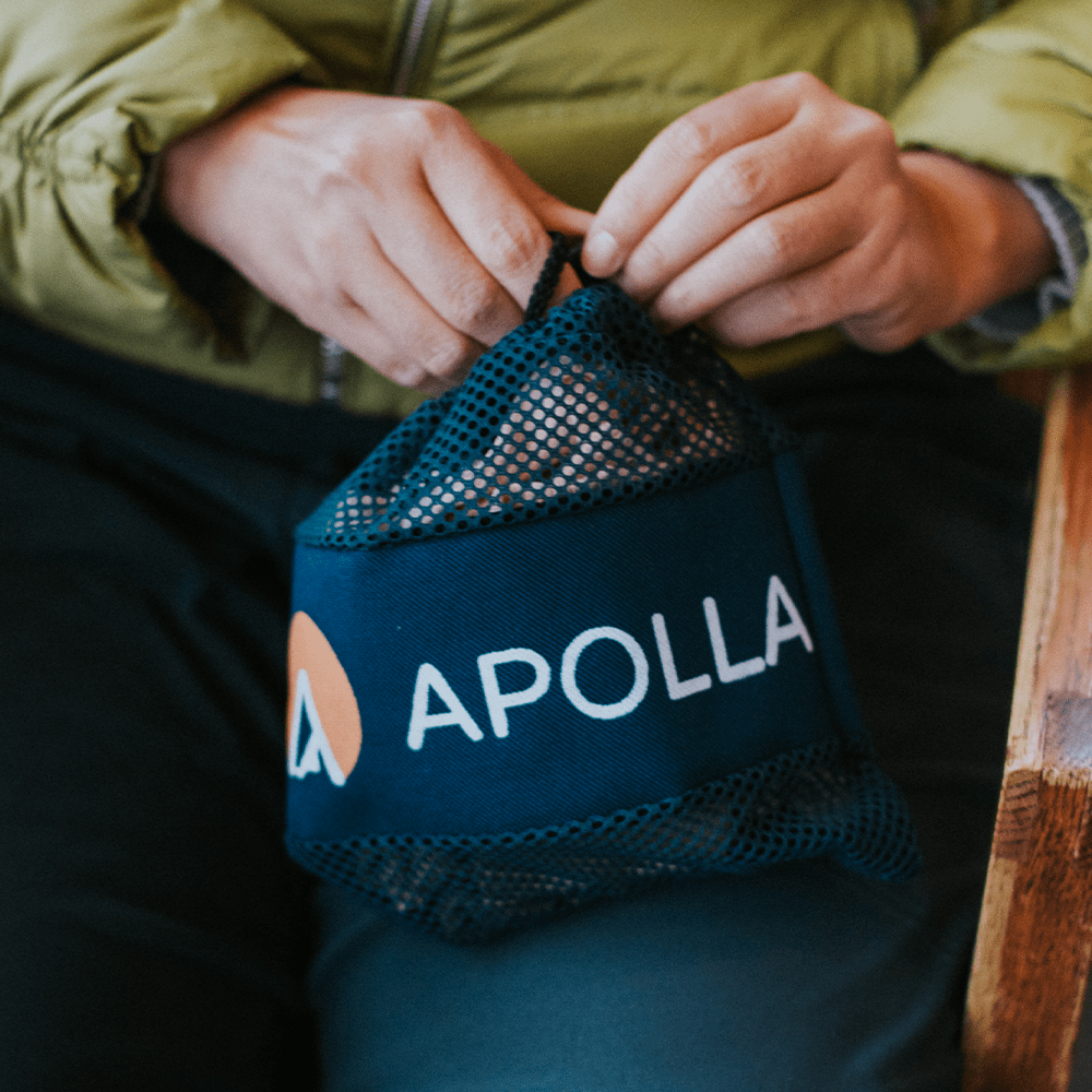 Woman holding Apolla Mesh Bag with compression socks in it