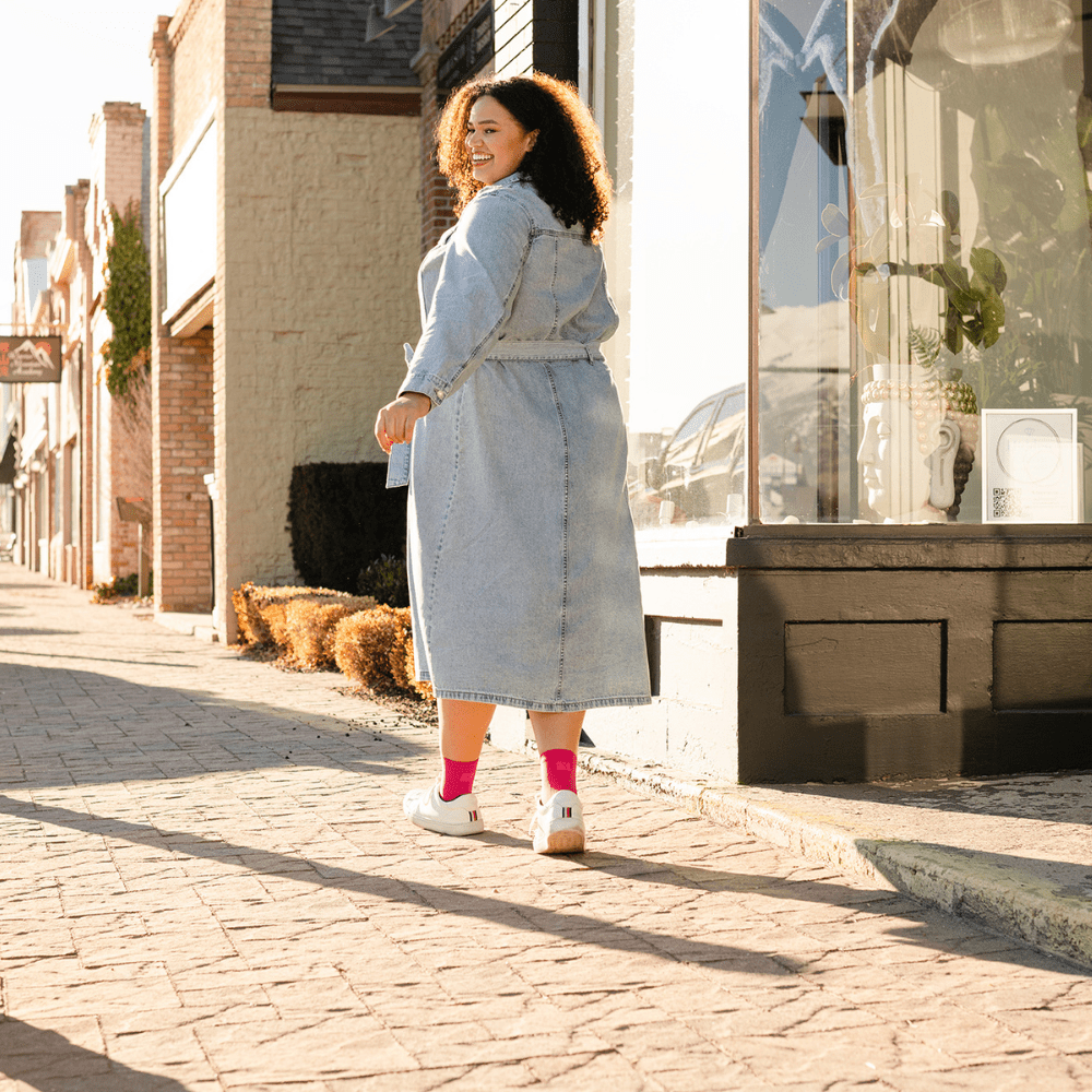 Compression crew socks with ankle support worn by woman walking through town