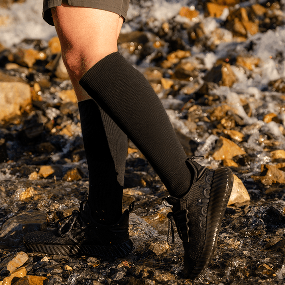Black medical compression socks worn hiking