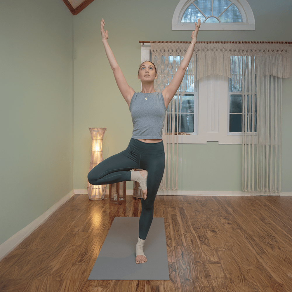Joule ankle compression sleeve worn by woman doing yoga