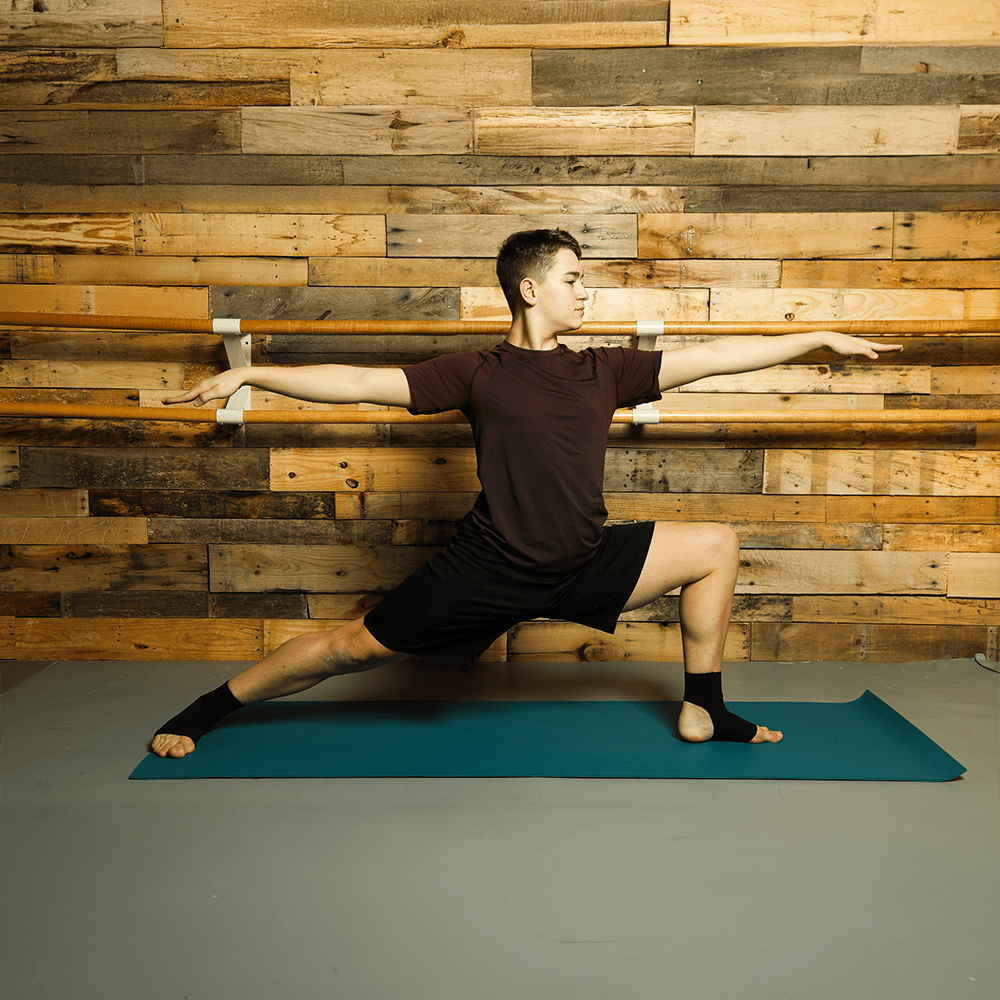 Black plantar fasciitis socks worn by man doing yoga