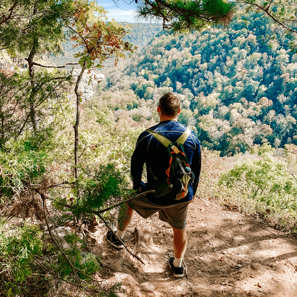 Man hiking while wearing crew socks with ankle support