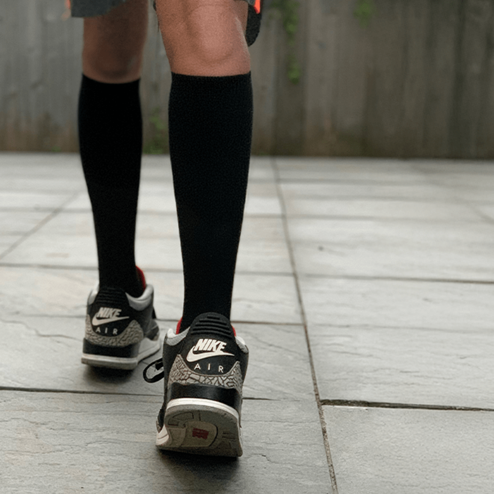 Black knee high compression socks worn for basketball