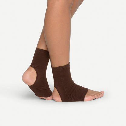 Woman wearing plantar fasciitis sleeve with barefoot arch support