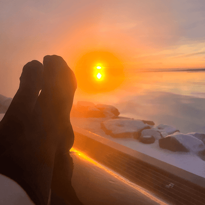 Infinite black boot socks worn at sunrise in Iceland