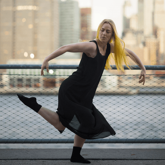 Woman dances in black crew compression socks with ankle support